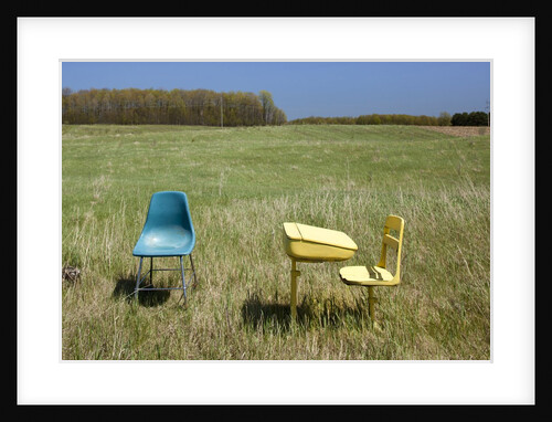 Abandoned school desk and chairs in farmer's field by Anonymous