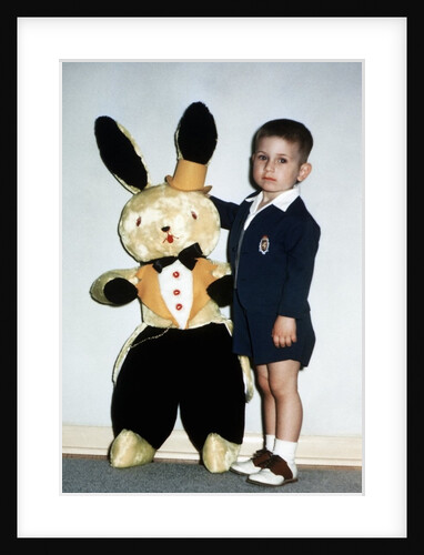 Little boy stands with his large Easter bunny, ca. 1954 by Anonymous
