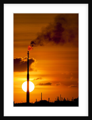 Flames and smoke billow from natural gas flare at Valero Oil Refinery at sunset by Anonymous