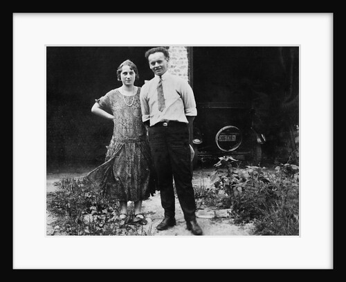 Young couple stands in front of their garage, ca. 1925 by Anonymous