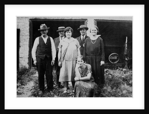 Family standing in front of garage, ca. 1925 by Anonymous