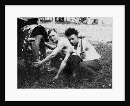 Young men change a tire on an automobile, ca. 1918 by Anonymous