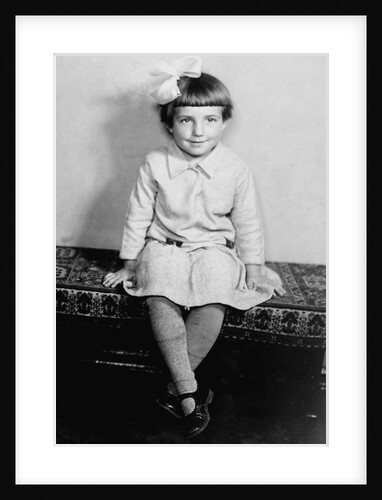 Young girl sits on a sofa, ca. 1933 by Anonymous