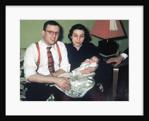 Young couple holding baby boy in christening gown, ca. 1952 by Anonymous