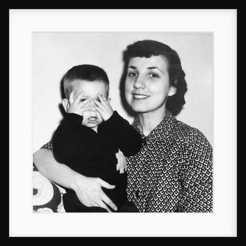 Mother holding son playing peek-a-boo, ca. 1955 by Anonymous