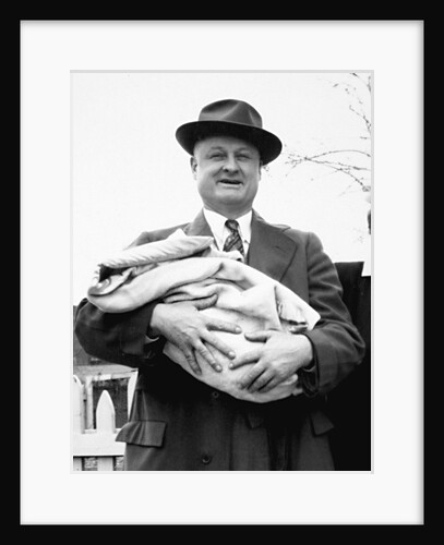 Mature man holds a baby, ca. 1950 by Anonymous