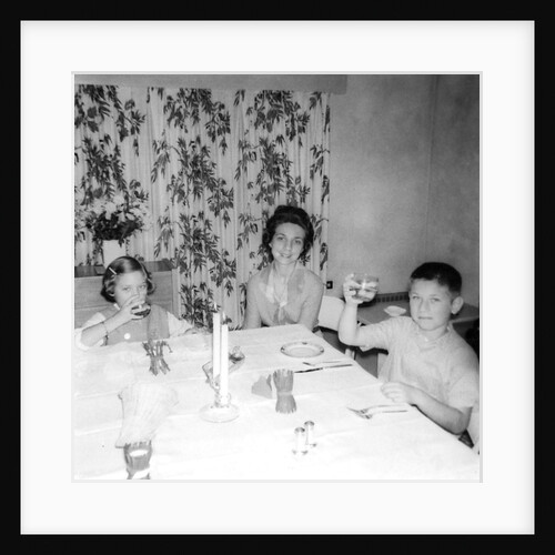 Mother with children at the dinner table, ca. 1962 by Anonymous