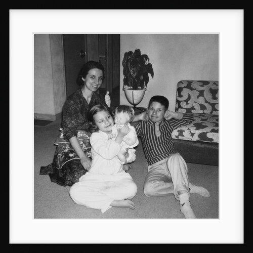 Mother with son and daughter in living room, ca. 1960 by Anonymous