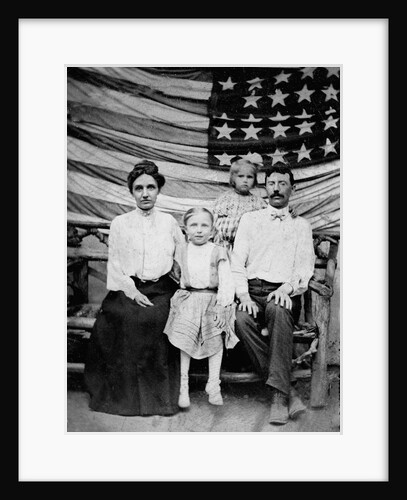 Family pose in front of American Flag, ca. 1898 by Anonymous