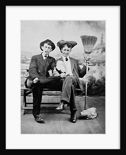 Two young men on a bench with a broom, ca. 1900 by Anonymous