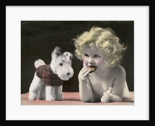 Child eating cookie next to stuffed toy dog by Anonymous