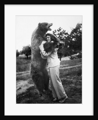 Woman embraces a stuffed bear, ca. 1940 by Anonymous