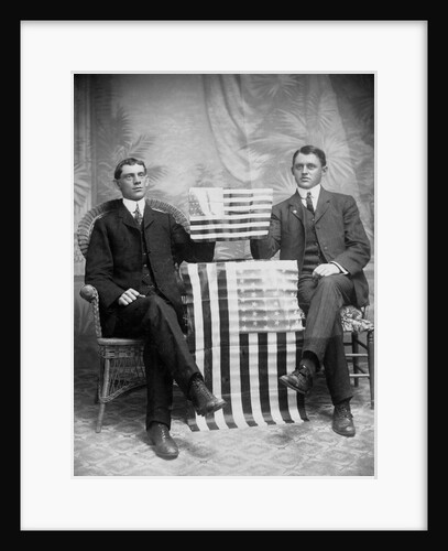 Two men pose with American flags, ca. 1895. by Anonymous