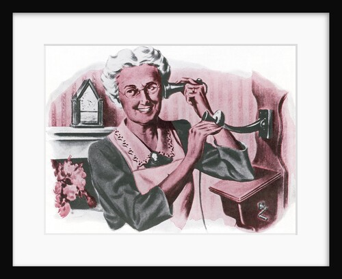 Grandmother on a crank wall telephone by Anonymous