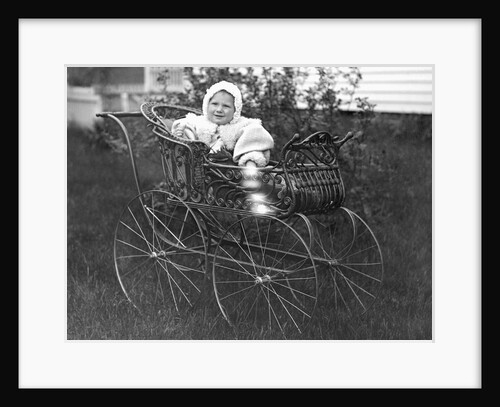 Baby in a baby carriage, ca. 1895. by Anonymous