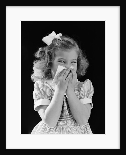 1940s little blond girl ribbon in hair holding tissue to nose sneezing by Anonymous