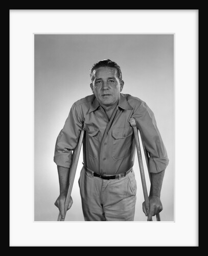 1960s man walking on crutches looking at camera by Anonymous