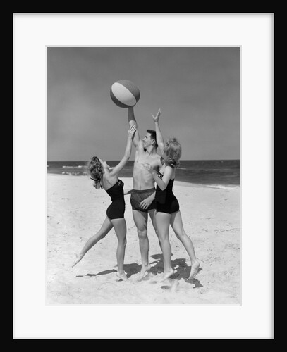 1950s teens jumping for beach ball wearing swim suits by Anonymous