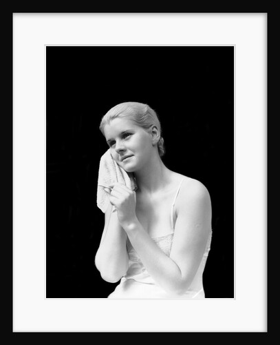 1930s blond woman washing face with washcloth towel by Anonymous