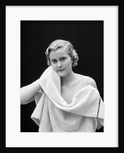 1930s woman drying face with towel looking at camera by Anonymous