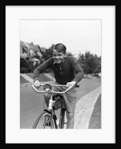 1930s smiling boy riding bicycle by Anonymous