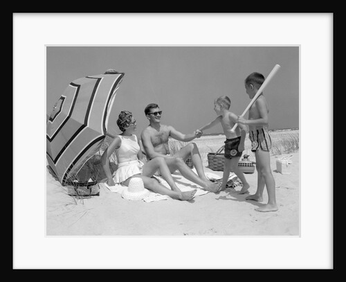 1960s at the beach two boys with baseball bat trying to pull up father seated next to mother so he will play with them by Anonymous