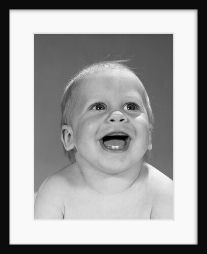 1960s portrait close-up of smiling baby boy showing first two teeth in bottom gums by Anonymous