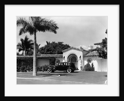 1930s car in circular driveway of tropical stucco spanish style home in sunset islands miami beach florida usa by Anonymous