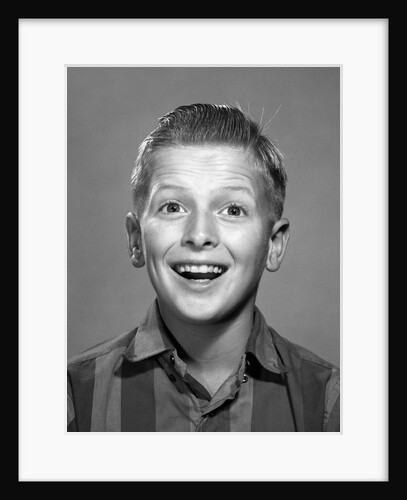 1960s portrait smiling wide-eyed happy surprised teenage boy looking at camera by Anonymous