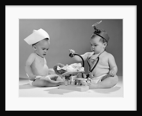 1960s two babies playing doctor and nurse with doll studio by Anonymous