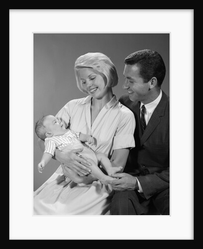 1960s happy mother and father smiling at their baby by Anonymous