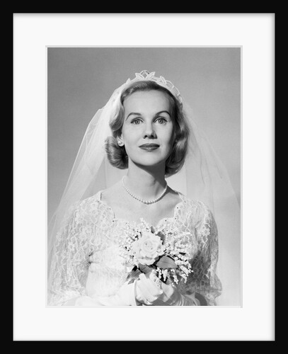 1950s portrait woman bride pearl necklace white gloves holding small bouquet looking at camera by Anonymous