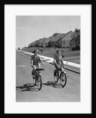 1950s teen boy girl riding bikes suburban neighborhood street by Anonymous