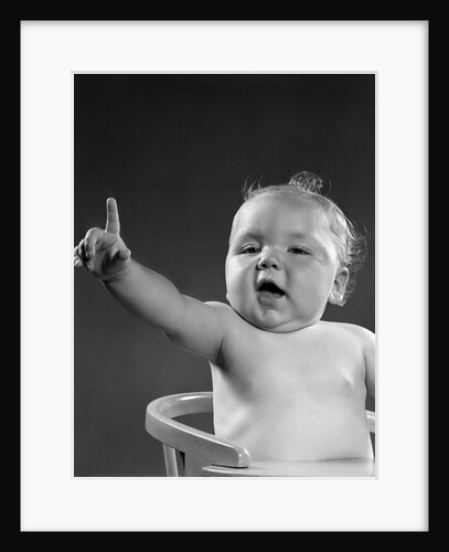 1940s 1950s baby sitting in chair arm and one finger raised objecting voting making a point looking at camera by Anonymous