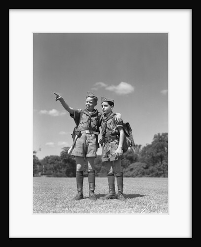 1950s two boy scouts one pointing wearing hiking gear uniforms by Anonymous