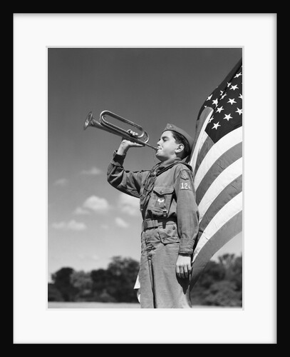 1950s profile of boy scout in uniform standing in front of 48 star american flag blowing bugle by Anonymous