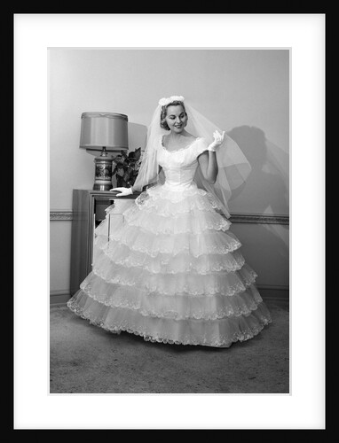 1950s 1960s bride in full gown veil & white gloves standing in room with open door by Anonymous