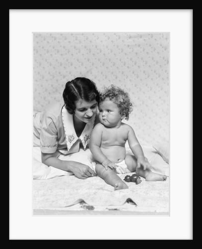 1920s 1930s woman mother lying sitting with baby on blanket by Anonymous