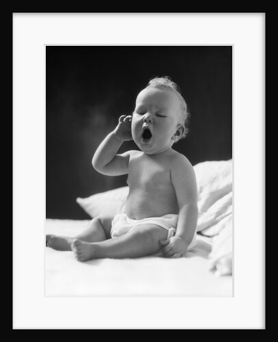 1930s baby sitting up in bed facing camera yawning tired sleepy by Anonymous