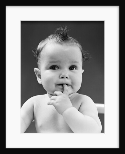 1940s thoughtful baby with finger in mouth by Anonymous