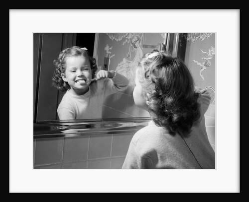 1950s girl looking in bathroom mirror brushing teeth by Anonymous