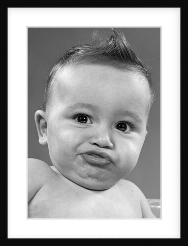 1950s baby making a funny face and bronx cheer noise looking at camera by Anonymous