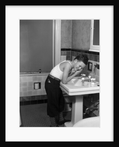 1930s boy washing face at bathroom sink by Anonymous