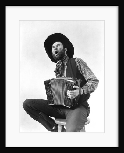 1930s cowboy playing accordion & singing by Anonymous