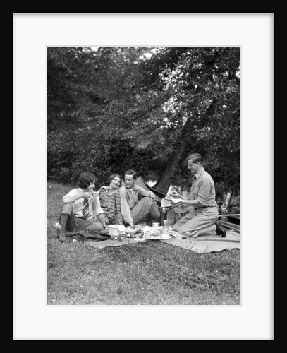 1920s four people two couples men women sitting on ground enjoying a picnic by Anonymous