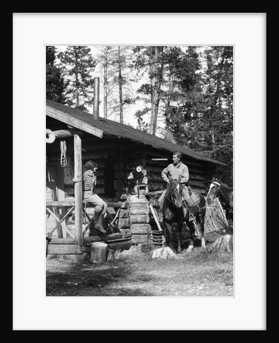 1920s 1930s couple in front of log cabin woman sitting on porch railing man on horse alberta canada by Anonymous