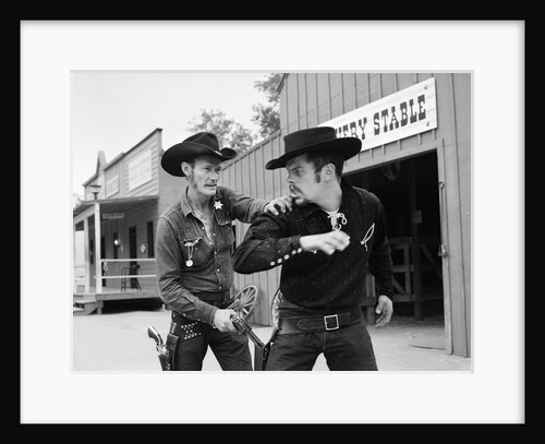 1950s 1960s cowboy sheriff marshall nabs arrest gunfighter outlaw near livery stable by Anonymous