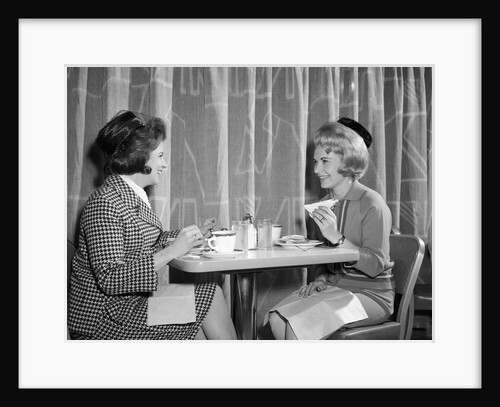 1960s two women having lunch in coffee shop restaurant by Anonymous