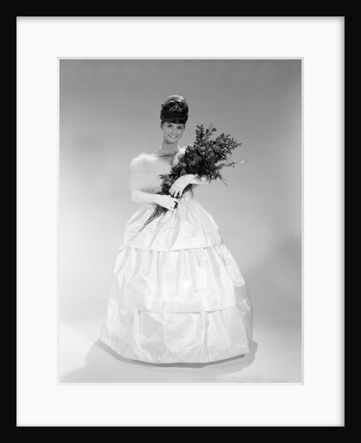 1960s pretty young woman in evening dress at beauty pageant wearing fur stole and tiara holding bouquet of roses looking at camera by Anonymous