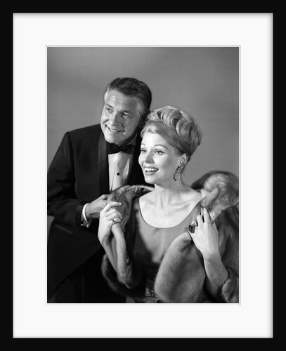 1960s 1970s couple in evening wear man in tuxedo woman in fur coat by Anonymous